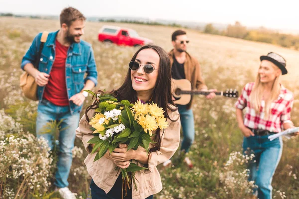 Group Young People Walking Field Guitar Flower Bouquet — стоковое фото
